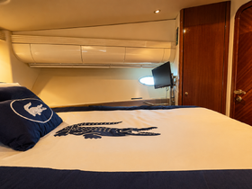 Cozy cabin interior featuring a stylish bed with a crocodile design, perfect for relaxing on a boat getaway.