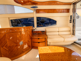 Interior view of a luxurious boat cabin featuring elegant seating and polished wood finishes, perfect for relaxing on the water.