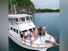 A lively group celebrates aboard a yacht, enjoying the beautiful surroundings and each other's company — perfect for memorable outings and gatherings on the water.