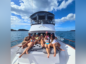 A lively group enjoys a fun day on the deck of a boat, soaking up the sun and celebrating together — perfect for memorable outings on the water.
