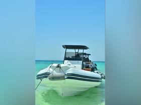 A sleek boat anchored in crystal-clear turquoise waters, with guests preparing for an exciting day on the ocean — perfect for adventure seekers and water enthusiasts.
