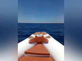 A sleek speedboat captured from the front, gliding over deep blue waters under a clear sky — perfect for thrilling adventures on the open sea.