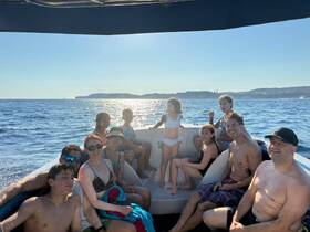 A joyful group of family and friends enjoys a sunny day on the water, creating lasting memories aboard their boat. Perfect for family outings and summer adventures.