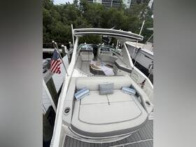 A cozy interior view of a Sea Ray boat featuring comfortable seating and a welcoming atmosphere, perfect for relaxing on the water.