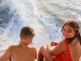Two children enjoy a fun day on the water, capturing the joy of boating and adventure. Perfect for family outings and summer memories.
