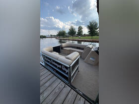 Interior view of a spacious pontoon boat seating area, perfect for relaxing and enjoying time on the water.