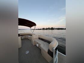 Interior view of a comfortable lounge area on a pontoon boat, perfect for relaxing while enjoying scenic waterfront views.