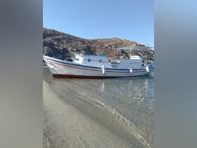 A picturesque view of a boat docked on a sandy shore, showcasing its classic design against a rocky backdrop — perfect for fishing trips or coastal explorations.