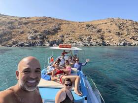A cheerful group enjoys a sunny day on a boat, capturing the essence of fun and celebration on the water.