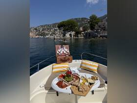 A beautifully arranged charcuterie spread featuring meats, cheeses, and fruits on a boat, perfect for a relaxing day on the water.