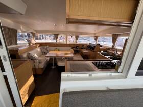 A spacious and well-appointed interior of a boat featuring a cozy seating area and dining space, perfect for relaxing and enjoying meals while on the water.