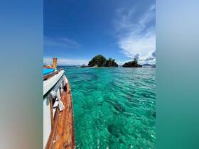 A stunning view of a boat gliding through crystal-clear waters, with lush islands in the background, perfect for showcasing tropical adventures.