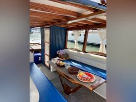A beautifully designed interior of a boat featuring comfortable seating and a dining area, ideal for enjoying meals while cruising on the water.