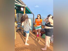 A lively group of friends enjoys a fun celebration on the deck of a boat, capturing the essence of a perfect day on the water.