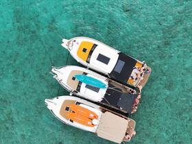 Aerial view of multiple boats anchored in clear turquoise waters, with a lively group enjoying the sun and water activities — perfect for a fun day on the water.