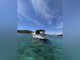 A boat anchored in crystal-clear waters with guests enjoying the sun — perfect for a day of relaxation and fun on the water.