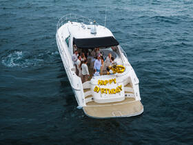 A lively birthday celebration aboard a yacht, featuring a group of friends enjoying the festivities on the water — perfect for memorable parties and special occasions.
