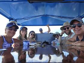 A cheerful group of friends enjoys their time aboard a boat, capturing the essence of camaraderie and fun on the water.