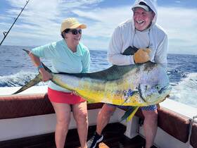 A joyful moment on the water as two anglers proudly display their impressive catch, celebrating a successful fishing trip.