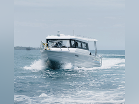 A sleek speedboat named 'Karibu 1' cuts through the waves, showcasing its dynamic design and performance on the water.
