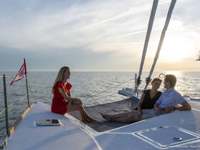 A couple enjoys a romantic moment on the deck of a yacht at sunset, creating the perfect backdrop for memorable celebrations on the water.