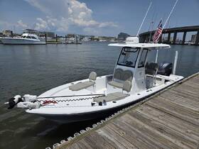 A sleek center console boat docked at the marina, showcasing its modern design and features, perfect for fishing or leisure outings.
