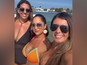 Three friends pose together in stylish swimwear, enjoying a sunny day by the water — perfect for beach outings and summer celebrations.