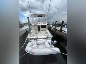 A rear view of a yacht docked at the marina, showcasing its sleek design and surrounding boats — perfect for fishing or leisure outings.
