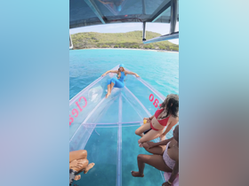 A vibrant group enjoys a sunny day on a boat, showcasing fun and relaxation against a stunning turquoise backdrop — perfect for beach outings and water adventures.