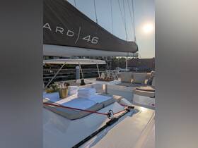 A beautifully arranged lounge area on a catamaran, featuring plush seating, towels, and refreshments, perfect for relaxing on the water.
