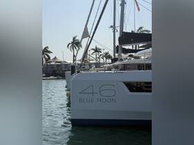 A close-up view of the 'Blue Moon' yacht docked, showcasing its sleek design and name, perfect for luxury sailing experiences.