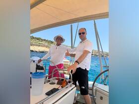 Two friends enjoy a sunny day on the boat, showcasing camaraderie and fun on the water — perfect for memorable outings and adventures.