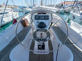 A detailed view of the helm area inside a yacht, showcasing the steering wheel and console, perfect for navigation and sailing adventures.