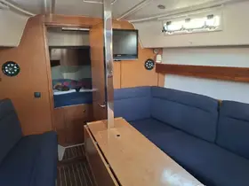 Interior view of a cozy boat cabin featuring comfortable seating and a well-equipped helm, perfect for relaxing during a sailing adventure.