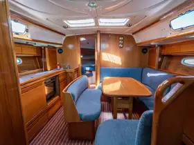 A cozy interior view of a boat's cabin featuring comfortable seating and a dining area, perfect for relaxing during your nautical adventures.