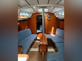 Interior view of a cozy boat cabin featuring comfortable seating and wooden accents, ideal for relaxing during a sailing trip.