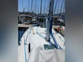 A clear view of the deck of a sailboat docked at the marina, showcasing its rigging and layout — perfect for sailing enthusiasts and boaters.