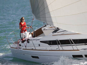 A woman skillfully navigates a yacht while sailing through vibrant ocean waters, showcasing the thrill of sailing adventures.