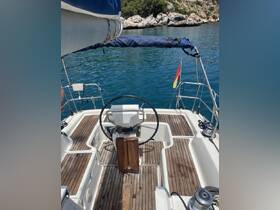 A detailed view of the helm area inside a sailboat, showcasing the steering wheel and wooden flooring, perfect for navigating serene waters.