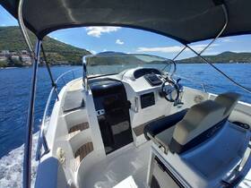 A well-equipped helm area of a boat showcasing the console and seating, perfect for navigating the open waters in comfort.