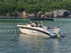 A sleek speedboat named 'Saver' is docked in calm waters, surrounded by lush greenery — perfect for a day of relaxation on the water.