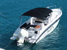 A sleek speedboat docked in clear turquoise waters, showcasing its modern design and inviting features — perfect for day trips and water adventures.