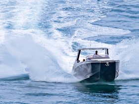 A sleek speedboat cuts through the waves, showcasing an exhilarating ride on the open water — perfect for adventure seekers and water sports enthusiasts.