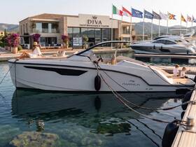 A stylish yacht is docked with a woman relaxing on the deck and children seated nearby, showcasing a perfect day at the marina.