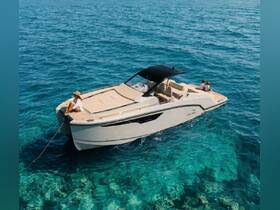 A couple enjoys a sunny day on a sleek boat, surrounded by crystal-clear waters — perfect for a relaxing getaway on the ocean.