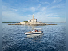 A lively group enjoys a scenic boat ride near a picturesque lighthouse, capturing the essence of coastal adventures and exploration.