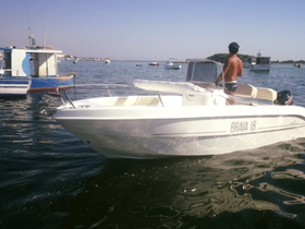 A sleek Brava 18 speedboat is seen in the water, showcasing its design while a person stands at the helm, perfect for leisurely outings on the water.