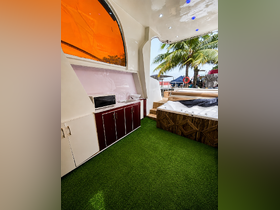 Interior view of a stylish boat cabin featuring modern amenities, including a kitchenette and a jacuzzi, perfect for relaxation on the water.