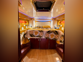 A luxurious cabin interior featuring a plush bed and elegant decor, perfect for relaxing on a boat getaway.