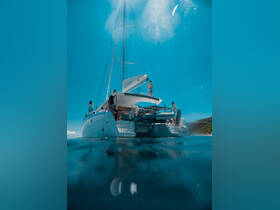 A lively scene aboard a catamaran with guests enjoying the sun and water, perfect for a fun day out on the ocean.